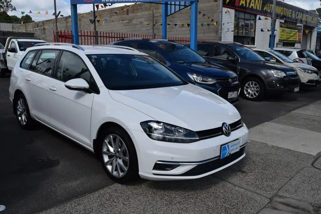 Front passenger side view of the white 2020 Volkswagen Golf Comfortline wagon